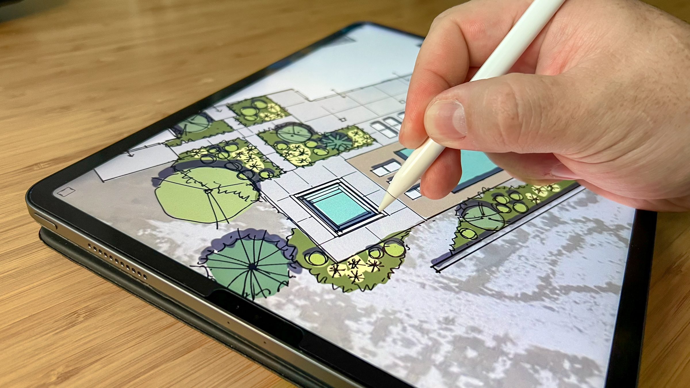 Hand drawing landscape on tablet with stylus.
