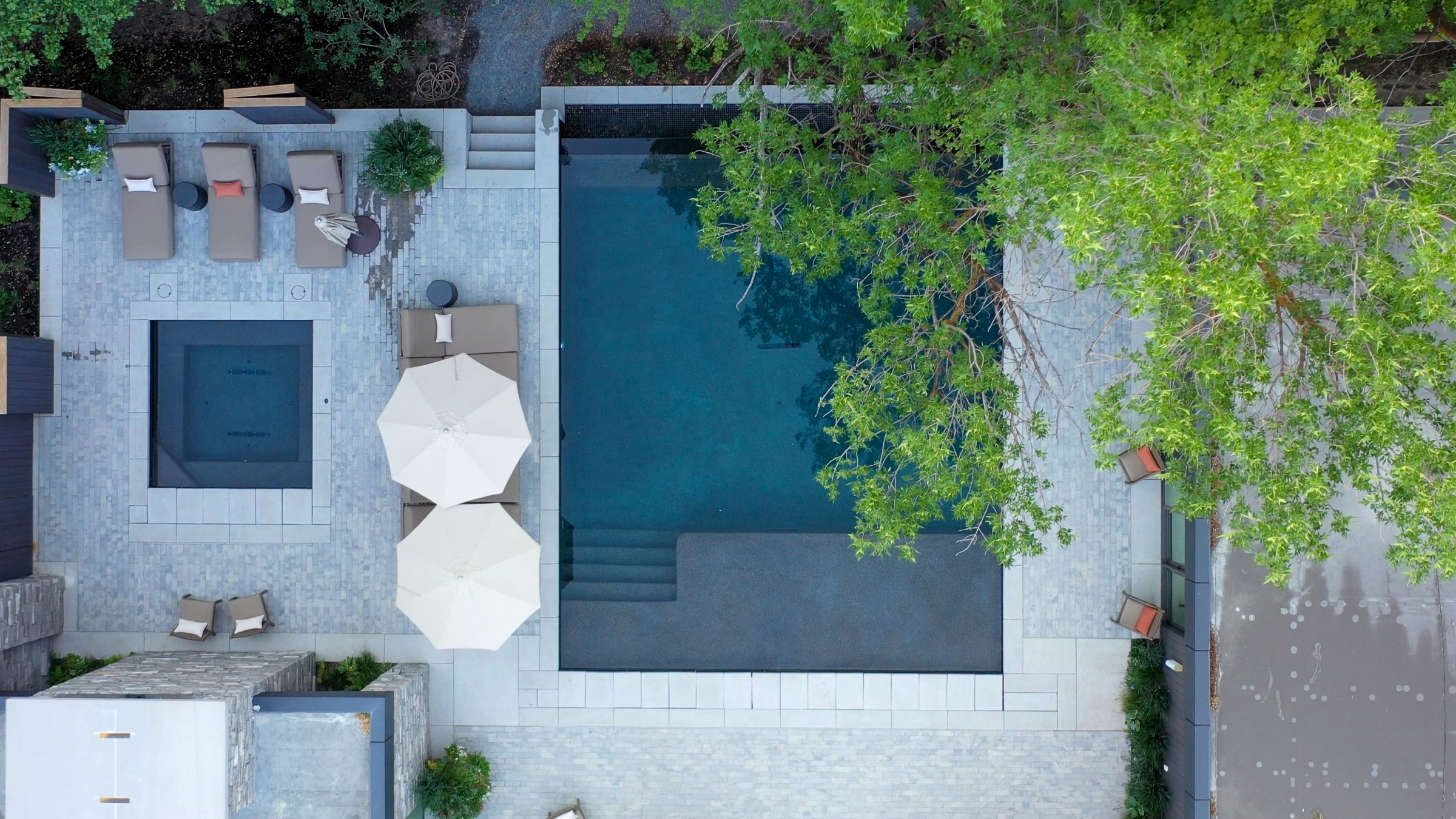 Aerial view of pool with lounge chairs and umbrellas.