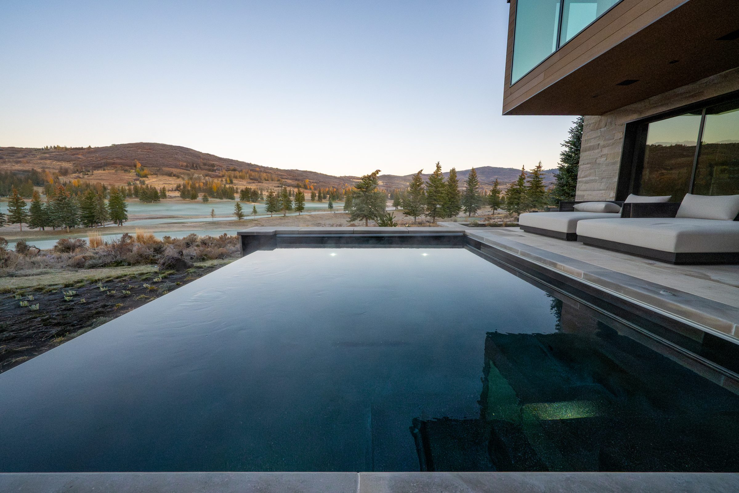 Infinity pool with scenic mountain view.
