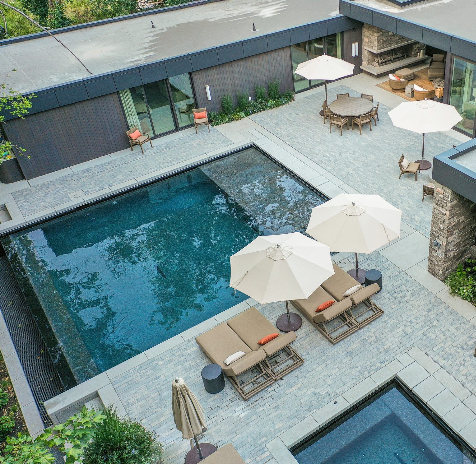 Modern patio with pool and relaxation area.