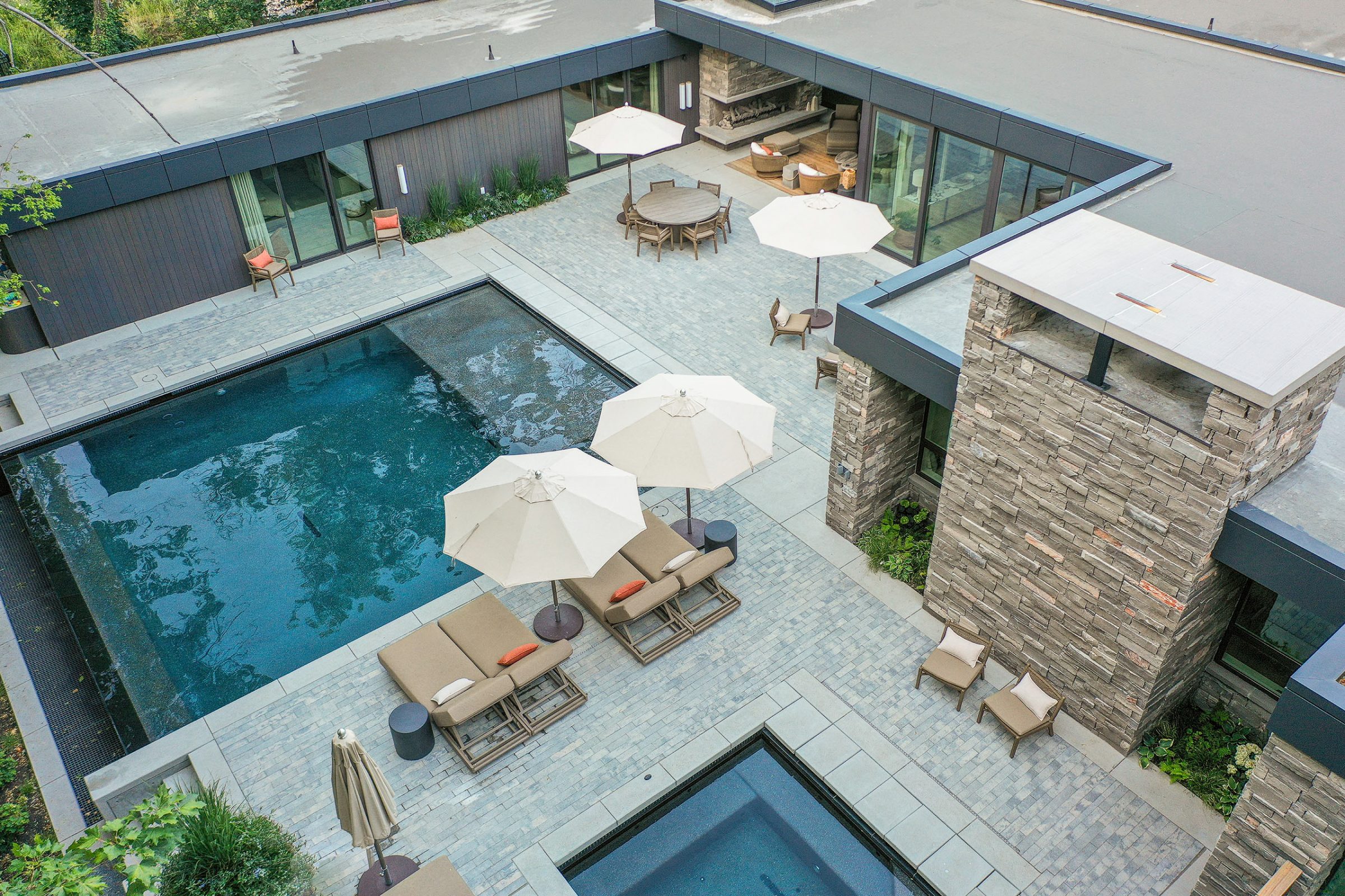 Modern house with pool and outdoor seating area.